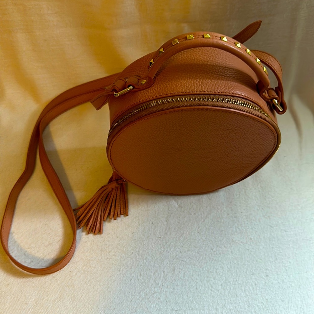 Round leather cross body bag with stud detail